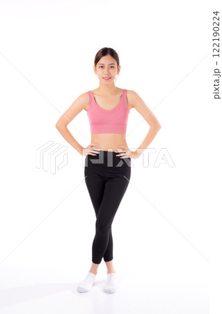 Portrait of beautiful young asian woman in sportwear smile and showing waist and abs isolated. 122190224