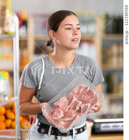 Woman chooses a lamb 122190566