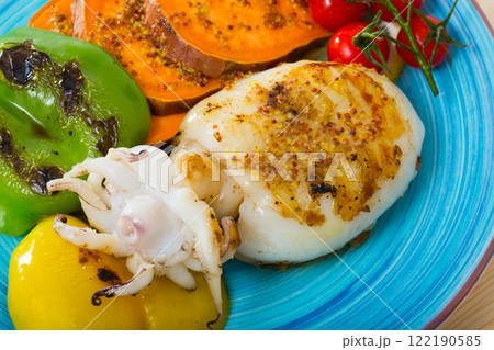 Photography of plate with sepia fried on a grill with pepper, boiled batat and honey-mustard sauce Photography of plate with sepia fried on a grill with pepper, boiled batat and honey-mustard sauce 122190585