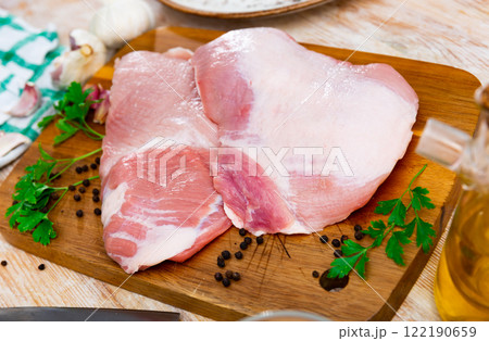 Preparation of raw pork cinch parsley and garlic on wooden board 122190659