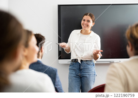 Young female teacher giving lecture to group of student Young female teacher giving lecture to group of student 122190759