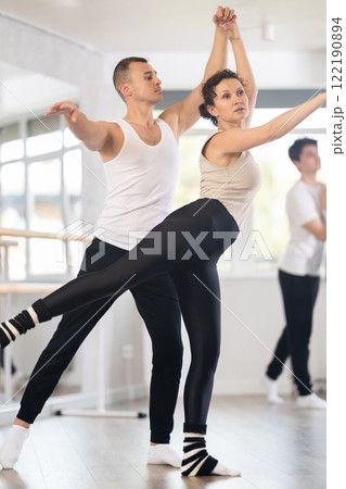 Young man and adult woman rehearsing pair ballet 122190894