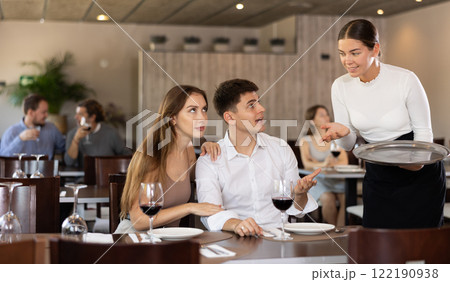 Waitress takes order from couple young man and woman Waitress takes order from couple young man and woman 122190938