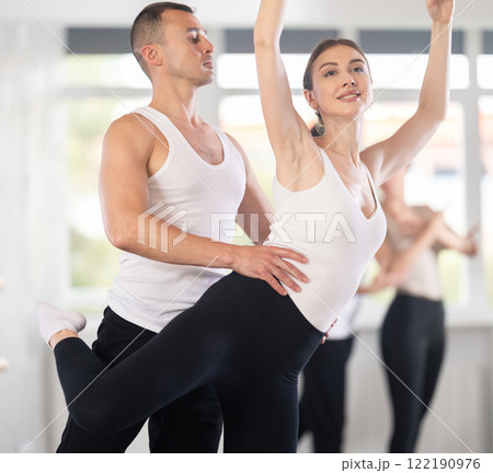 Young man and young woman rehearsing pair ballet Young man and young woman rehearsing pair ballet 122190976