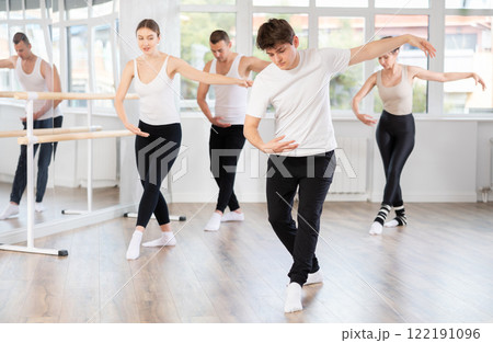 Young guy participating in group ballet class in choreography studio Young guy participating in group ballet class in choreography studio 122191096