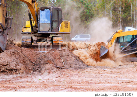 Tractor bulldozer is leveling ground earthmoving on construction site grading soil to prepare construction 122191507