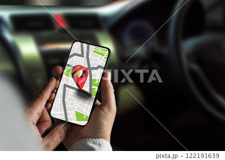gps map ,man using a smartphone displaying a map in a car gps navigation system 122191639