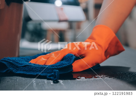 Janitor wiping table in office Janitor wiping table in office 122191983