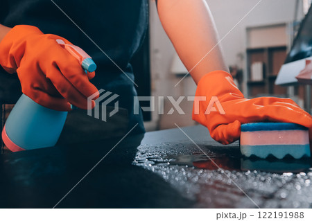 Janitor wiping table in office 122191988