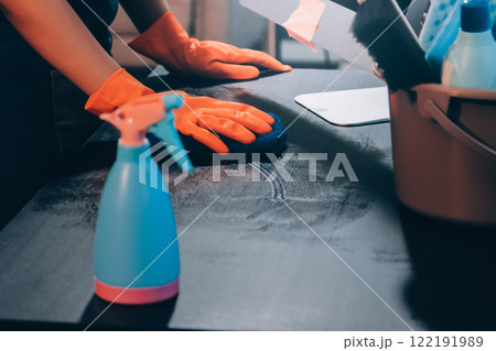 Janitor wiping table in office 122191989