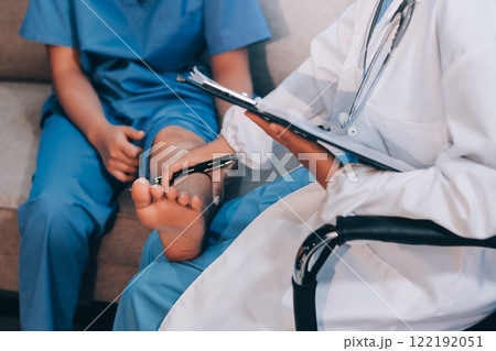Doctor giving a patient a leg treatment 122192051