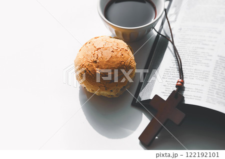Bread and wine symbolizing the holy blood and body of Jesus, the cross of Jesus Christ and the Bible, the background of the Holy Communion 122192101