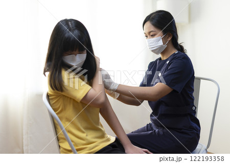 Asian Preteen Girl Getting Vaccinated, Receiving Coronavirus Vaccine Injection in clinic. Asian Preteen Girl Getting Vaccinated, Receiving Coronavirus Vaccine Injection in clinic. 122193358