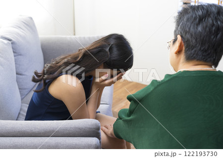 Asian psychologist doctor having session with young depressed woman in clinic. Psychology and mental therapy concept. Asian psychologist doctor having session with young depressed woman in clinic. Psychology and mental therapy concept. 122193730