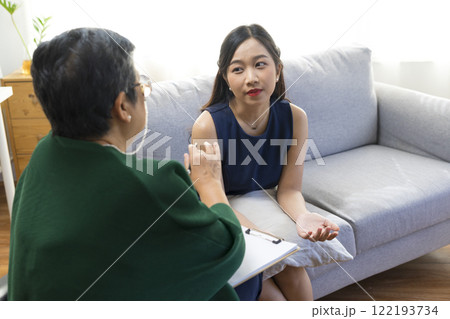 Asian psychologist doctor having session with young depressed woman in clinic. Psychology and mental therapy concept. Asian psychologist doctor having session with young depressed woman in clinic. Psychology and mental therapy concept. 122193734