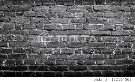 texture of an old black shabby brick wall with a distressed appearance, The dark masonry creates a grunge style aesthetic, perfect as a background or texture 122194565