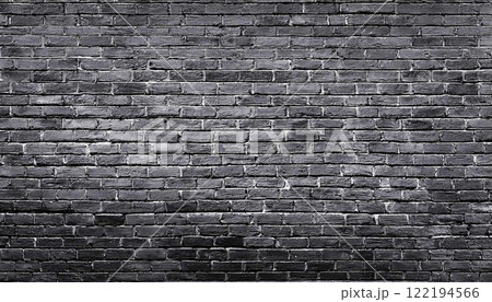 texture of an old black shabby brick wall with a distressed appearance, The dark masonry creates a grunge style aesthetic, perfect as a background or texture 122194566