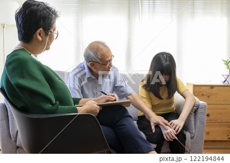 Parents telling the psychologist about family or child problems. Depressed girl and her parent or grandpa having session with psychiatrist in clinic. Parents telling the psychologist about family or child problems. Depressed girl and her parent or grandpa having session with psychiatrist in clinic. 122194844
