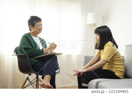 Depressed asian girl having consultation with psychologist at clinic. Depressed asian girl having consultation with psychologist at clinic. 122194901