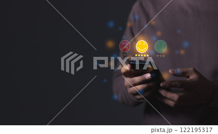 Young Man hand using smartphone mobile with five star to review and give 5 stars with very good Young Man hand using smartphone mobile with five star to review and give 5 stars with very good 122195317