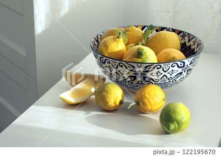 Wild yellow-green unripe lemons in plate. Environmentally friendly product. Eco-friendly pure natural product.  122195670