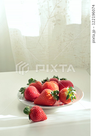 Group of sliced strawberries from home garden on plate. Sun day. Eco-friendly pure natural product. Group of sliced strawberries from home garden on plate. Sun day. Eco-friendly pure natural product. 122196074