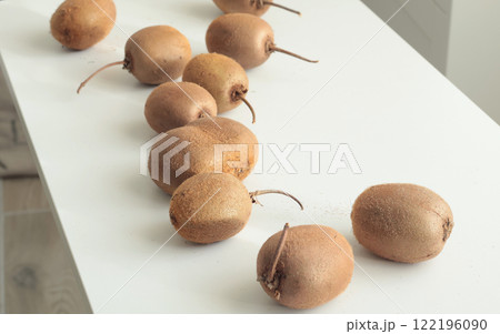 Group of kiwi with tails from home garden on white background. Eco-friendly pure natural product. Group of kiwi with tails from home garden on white background. Eco-friendly pure natural product. 122196090