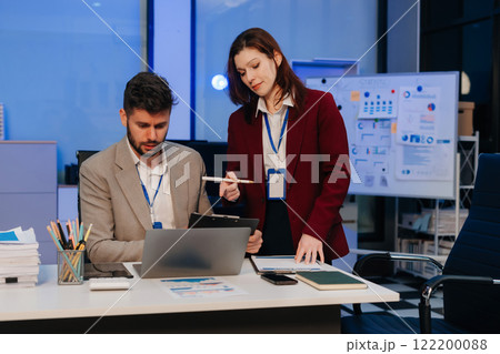 Diversity, business team working at office with laptop and documents on desk, financial adviser analyzing data, employees working overtime. 122200088