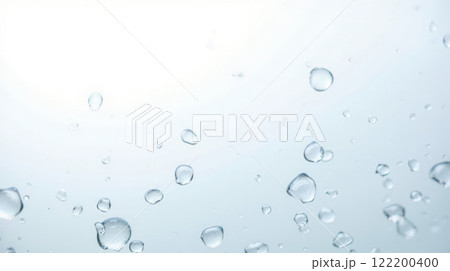 Water droplets on clear glass surface with light blue background, creating fresh and clean look. Perfect for themes of purity, hydration, and nature. Ideal for backgrounds, advertisement 122200400