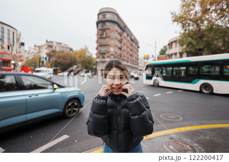 woman traveler visiting in Shanghai, China. Female Tourist with backpack sightseeing Wukang Mansion with Wukang Road and Middle Huaihai Road. landmark and popular for tourism attractions in Shanghai woman traveler visiting in Shanghai, China. Female Tourist with backpack sightseeing Wukang Mansion with Wukang Road and Middle Huaihai Road. landmark and popular for tourism attractions in Shanghai 122200417
