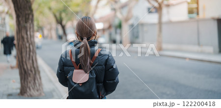 woman traveler visiting in Shanghai, China. Female Tourist with backpack sightseeing in Anfu road. landmark and popular for tourism attractions in Shanghai. Travel and vacation concept 122200418
