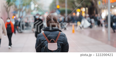 woman traveler visiting in Shanghai, China. Happy Female Tourist sightseeing in Nanjing road, shopping district of Shanghai. landmark and popular for tourism attractions. Travel and Vacation concept 122200421