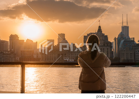 woman traveler visiting in Shanghai, China. Happy Female Tourist sightseeing Shanghai view of the bund in Lujiazui at sunset. landmark and popular for tourism attractions. Travel and Vacation concept woman traveler visiting in Shanghai, China. Happy Female Tourist sightseeing Shanghai view of the bund in Lujiazui at sunset. landmark and popular for tourism attractions. Travel and Vacation concept 122200447
