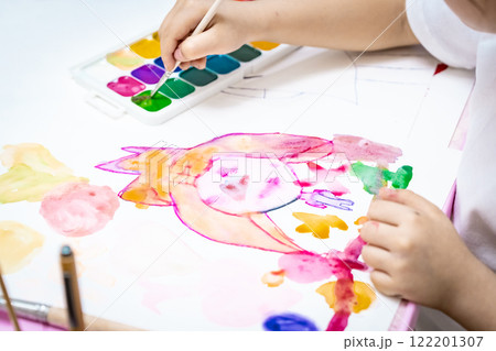child painting a picture with school supplies, preschool child painting, child drawing a rainbow, child doing homework. child painting a picture with school supplies, preschool child painting, child drawing a rainbow, child doing homework. 122201307