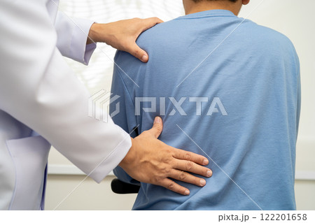 Physical therapy, Asian therapist doctor treat perform pain young man in hospital. Physical therapy, Asian therapist doctor treat perform pain young man in hospital. 122201658