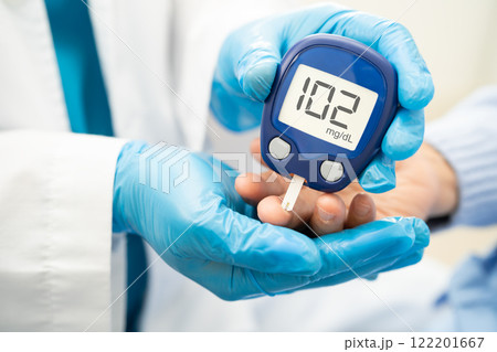 Doctor check diabetes from finger blood sugar level with finger lancet. 122201667