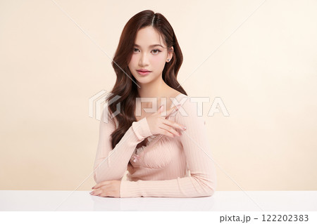 Beautiful young asian woman with clean fresh skin on beige background, Face care, Facial treatment, Cosmetology, beauty and spa, Asian women portrait. 122202383