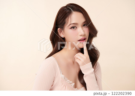 Beautiful young asian woman with clean fresh skin on beige background, Face care, Facial treatment, Cosmetology, beauty and spa, Asian women portrait. 122202390