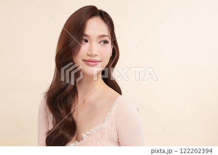 Beautiful young asian woman with clean fresh skin on beige background, Face care, Facial treatment, Cosmetology, beauty and spa, Asian women portrait. Beautiful young asian woman with clean fresh skin on beige background, Face care, Facial treatment, Cosmetology, beauty and spa, Asian women portrait. 122202394