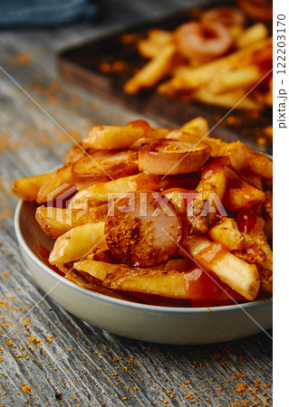 german currywurst and fries on a bowl 122203170