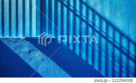 Minimalistic background with shadow on blue wall. Plaster texture 122204099