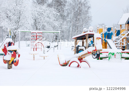Snow-covered children's playground in the park on winter day with lots of snow Snow-covered children's playground in the park on winter day with lots of snow 122204996
