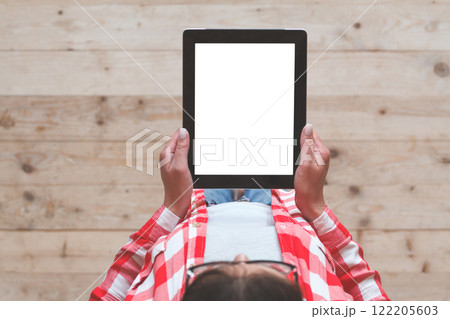 Woman using her tablet with blank of screen Woman using her tablet with blank of screen 122205603