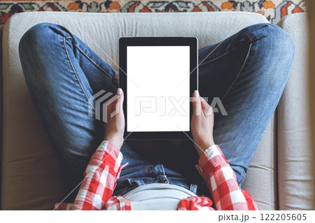 Woman using her tablet with blank of screen Woman using her tablet with blank of screen 122205605