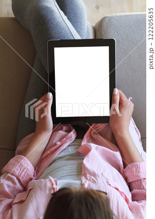Woman using her tablet with blank of screen Woman using her tablet with blank of screen 122205635