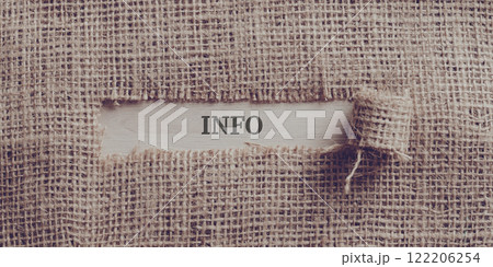 Rough linen fabric with a torn window in the middle with an INFO sign written in it Rough linen fabric with a torn window in the middle with an INFO sign written in it 122206254