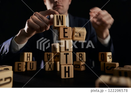 wooden cube with word wealth to health. safety in future and wellbeing wooden cube with word wealth to health. safety in future and wellbeing 122206578