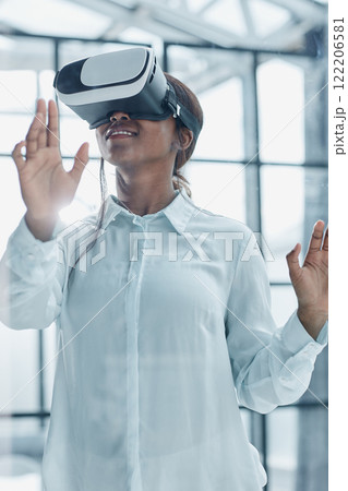 Businesswoman using vr glasses to view educational material and financial documents Businesswoman using vr glasses to view educational material and financial documents 122206581