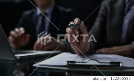 Close-up of a hand using a writing pen with a paperwork questionnaire or survey, 122206589