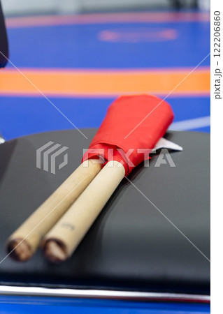 The referee's red and white flags are waiting for the referee on the chairs. 122206860